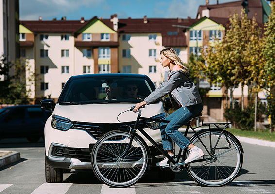 woman riding a bicycle on a crosswalk