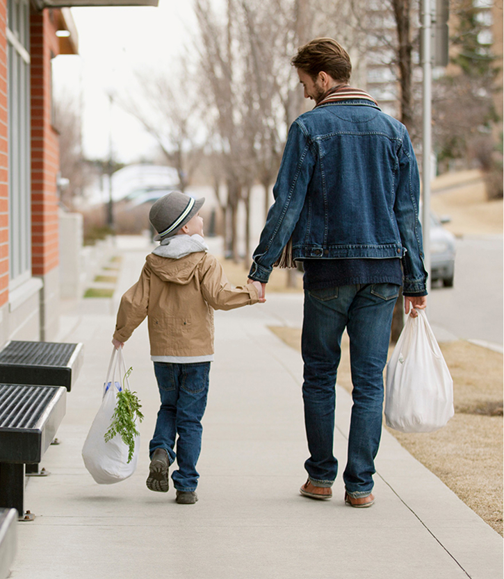 father walking with his son on a sidewalk