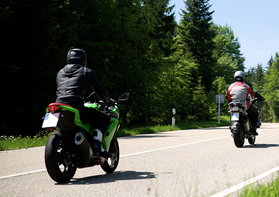 two people riding motorcycles