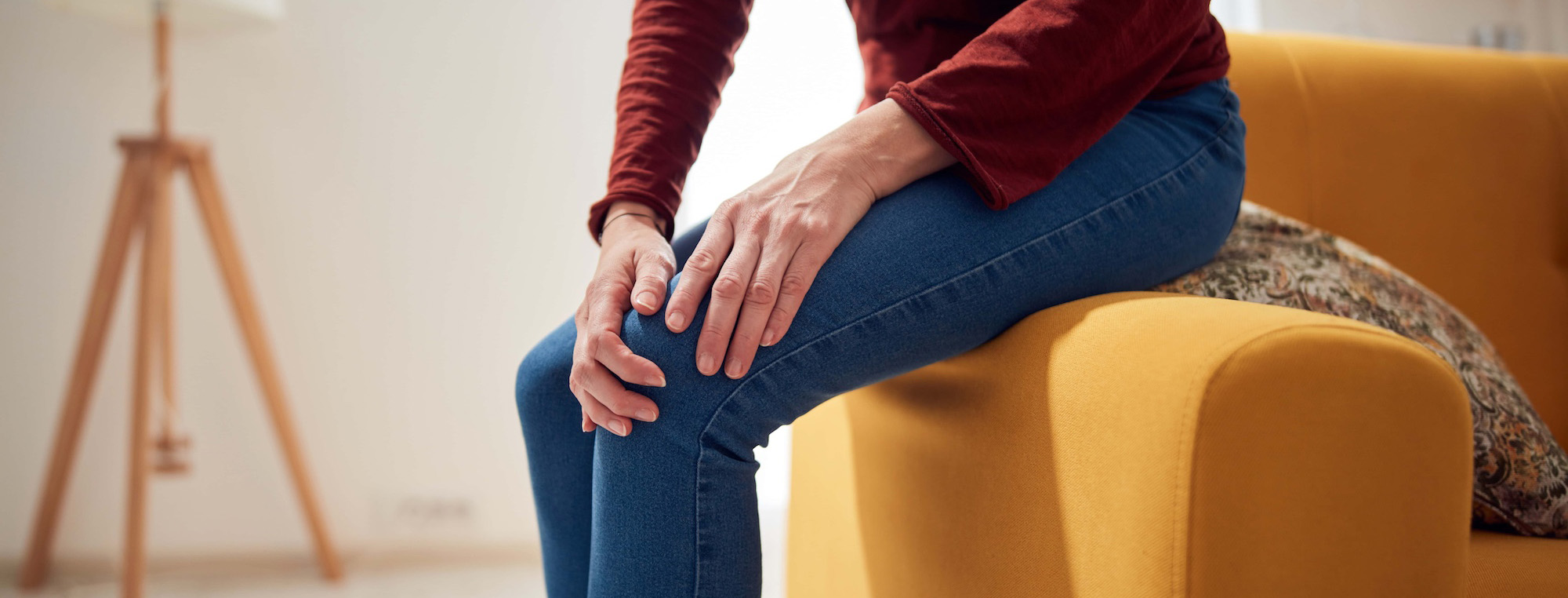 woman with knee and joint pain at home_